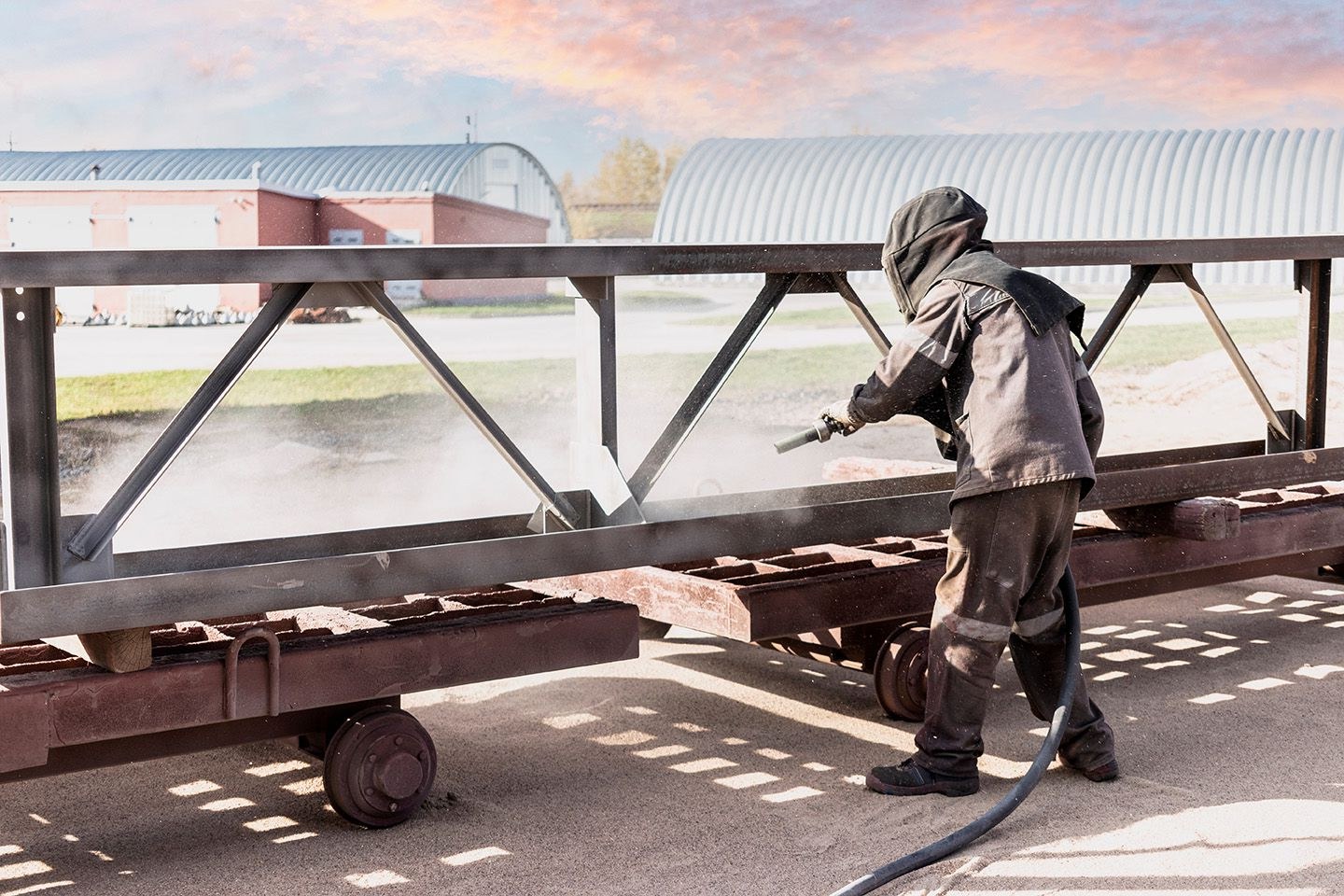 Operator media blasting a surface